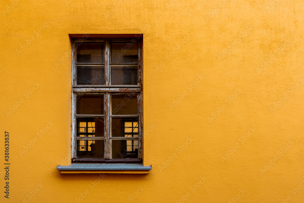 Old yellow house facade with wooden window Old yellow house facade with wooden window