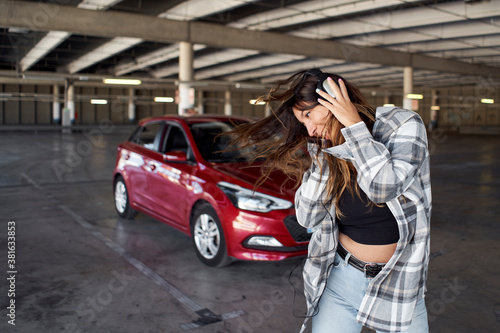 Young woman dancing in a parking lot. © CarlosBarquero