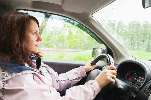 Young Caucasian woman drives a car