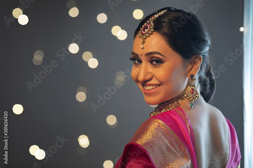 Woman in saree smiling confidently	