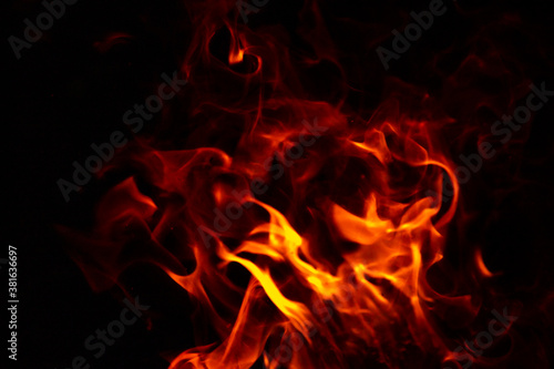Abstract glowing background. Flames on a dark background with sparks and smoke.
