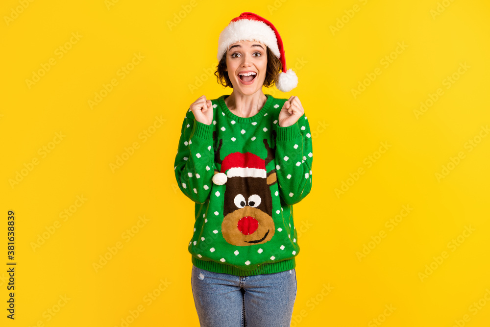 Crazy astonished girl celebrate x-mas christmas party lucky gift raise fists wear santa claus headwear reindeer decor sweater pullover isolated bright shine color background Crazy astonished girl celebrate x-mas christmas party lucky gift raise fists wear santa claus headwear reindeer decor sweater pullover isolated bright shine color background