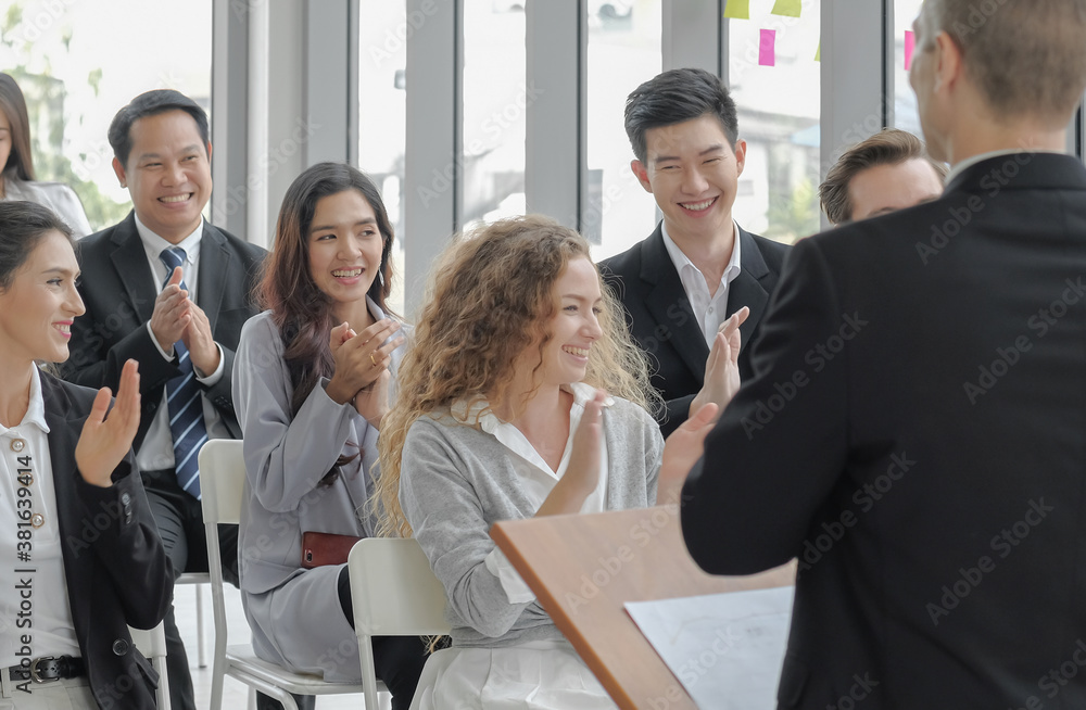 Candid business audience happy and smiley faces in seminar event. Young asian woman clapping hands together with others for congratulation to colleague at conference meeting room. Selective focus. Candid business audience happy and smiley faces in seminar event. Young asian woman clapping hands together with others for congratulation to colleague at conference meeting room. Selective focus.