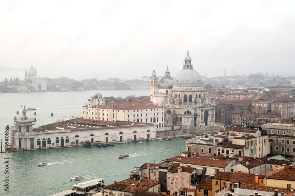Panorama with the red roofs, Adriatic sea and the most impressive historical buildings of the old romantic Venice, Italy