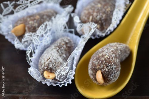 Cashew balls ( Cajuzinho ). Brazilian food, Comida brasileira, Brasil. Typical Brazilian sweet with the main ingredients: condensed milk, peanuts and cocoa powder rolled over crystal sugar
