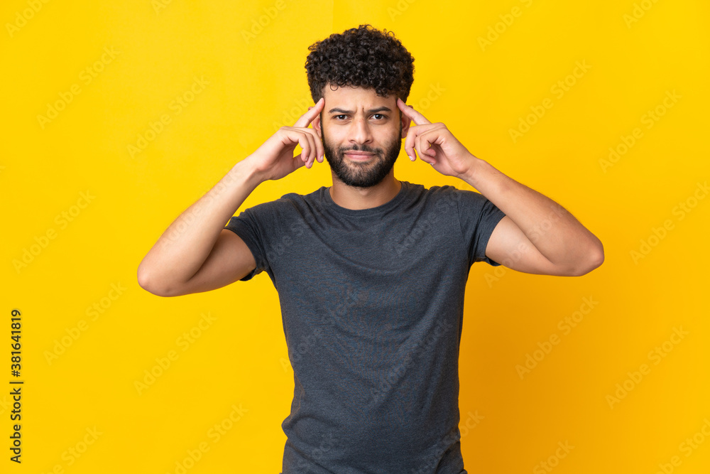 Young Moroccan man isolated on yellow background having doubts and thinking Young Moroccan man isolated on yellow background having doubts and thinking