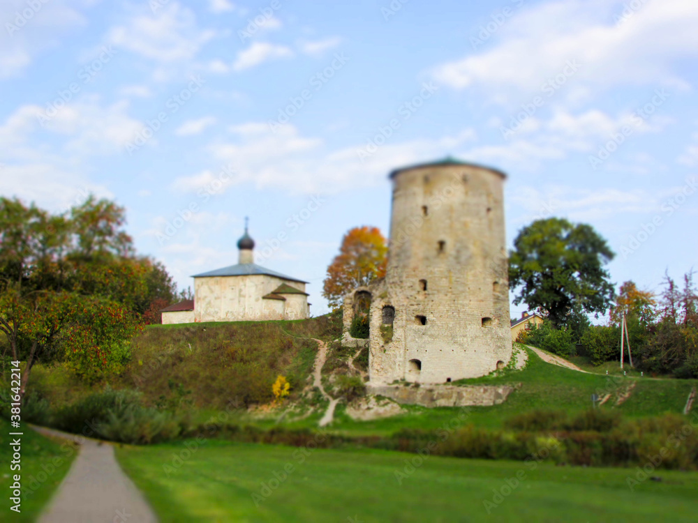 View of the medieval old stone Rattling tower in the Pskov city, Russia in the bright autumn day