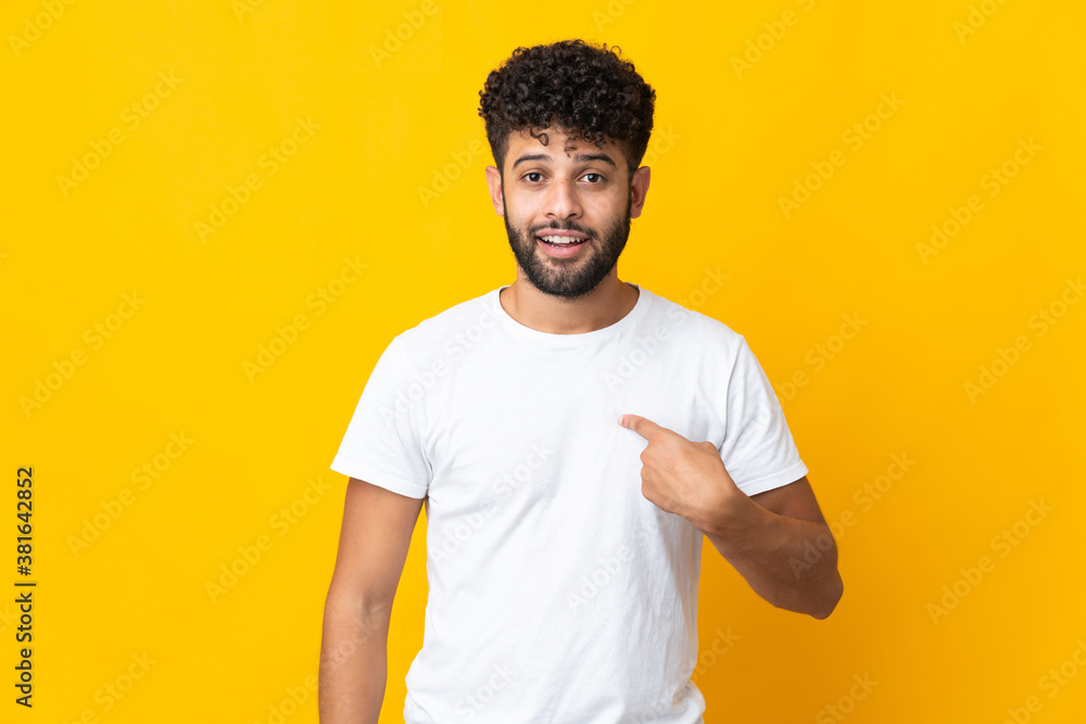 Young Moroccan man isolated on yellow background with surprise facial expression Young Moroccan man isolated on yellow background with surprise facial expression