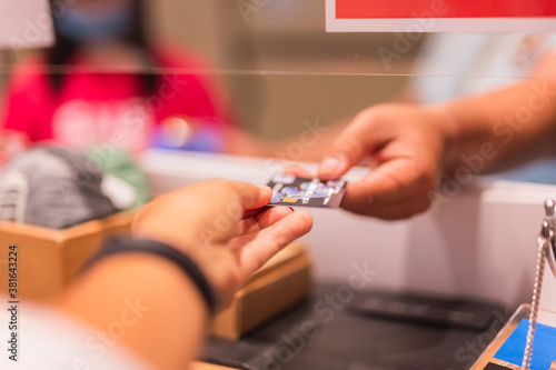 Man checkout paying with credit card at shopping store.