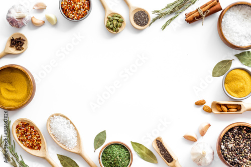 Set of Indian spices and herbs in wooden spoons, top view