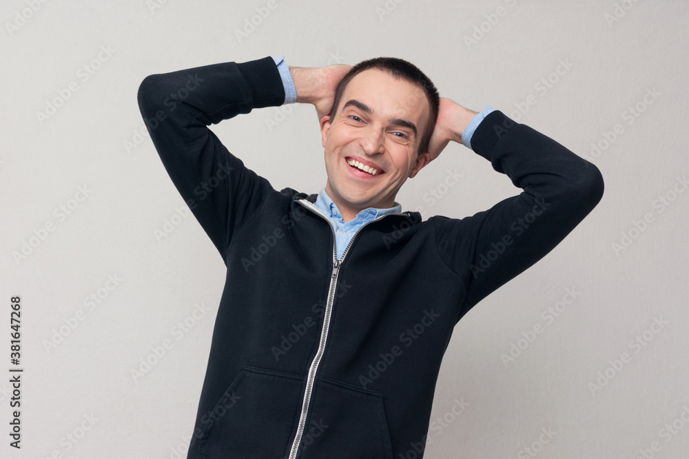 Happy young man laughing out loud at something joke. Concept of positive people emotions Happy young man laughing out loud at something joke. Concept of positive people emotions