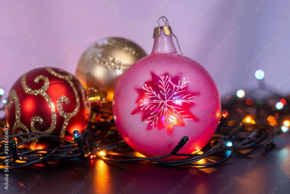 Christmas toys on a garland of light bulbs.
