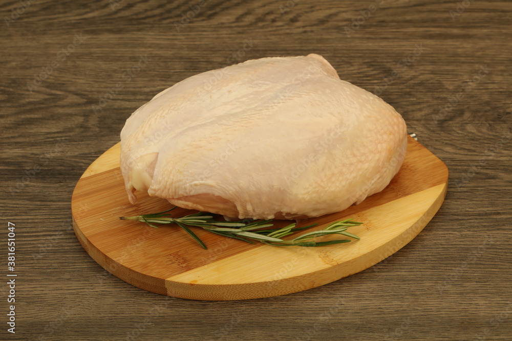 Raw whole chicken breast with skin