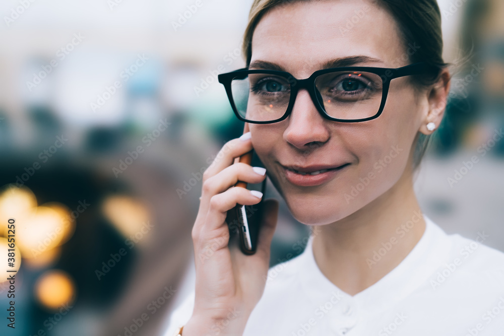 Cheerful young woman speaking on cellphone