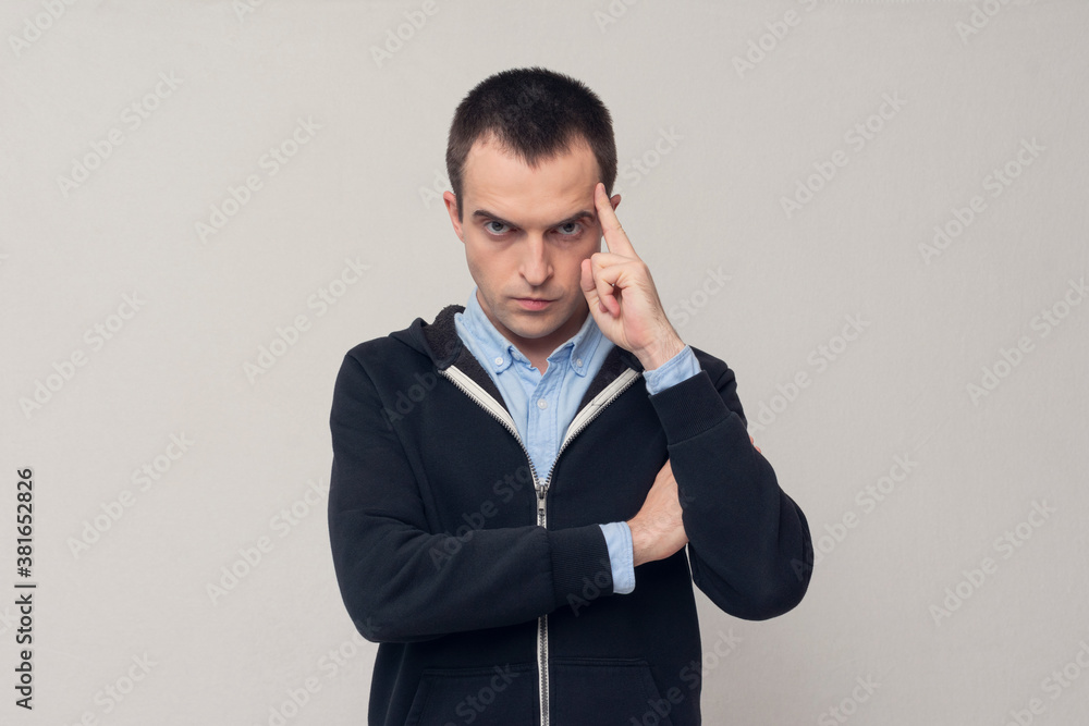 Serious man is concentrating on something, a portrait, a white background Serious man is concentrating on something, a portrait, a white background