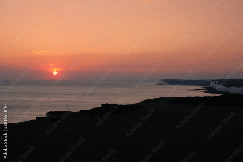 Sunset over the English Channel at Seven Sisters chalk cliffs Sunset over the English Channel at Seven Sisters chalk cliffs