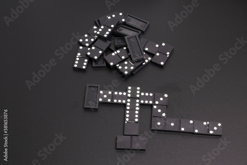 The black dominoes were laid out on a dark table. © Владимир Степанов