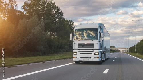 Wallpaper Mural Cargo truck with cargo trailer driving on a highway. White Truck delivers goods in early hours of the Morning - very low angle drive thru close up shot. Torontodigital.ca