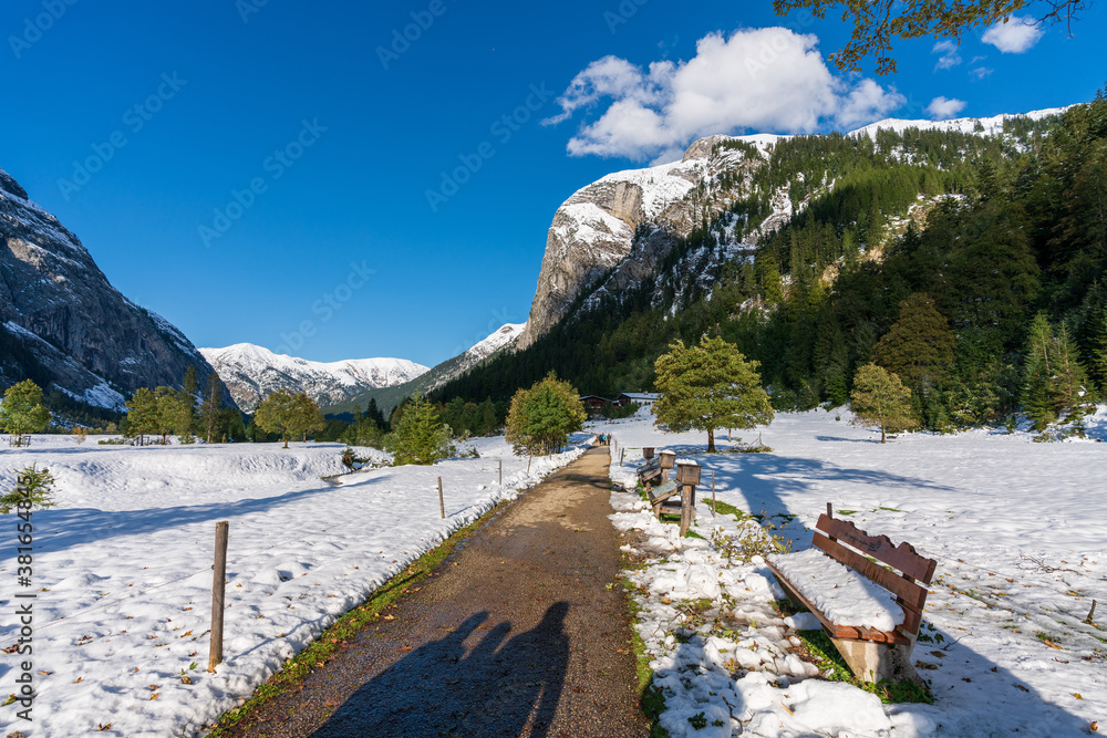 Markanter Baum mit Rastbank am großen Ahornboden im Karwendelgebirge Tirol Österreich mit ersten Schnee im September