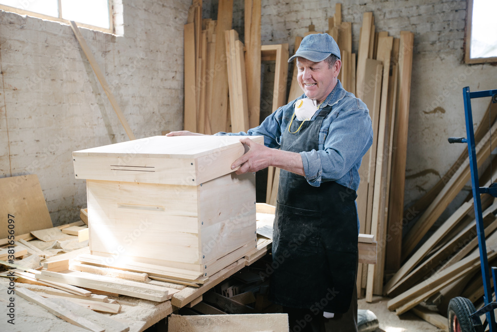 Carpenter man posing in carpentry workshop Carpenter man posing in carpentry workshop