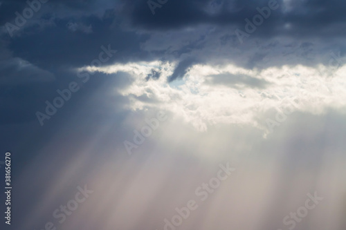 Sun lights through sky clouds very bright light as sign of hope and peace for inspirational wallpaper © Tanaly