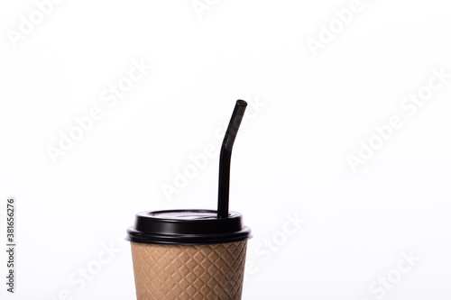 Modern craft disposable paper cup with eco-friendly black glass straw isolated on white background. Coffee to go, takeaway hot drinks, coffee shop cafe ads, recycling, reusable concept. Copy space