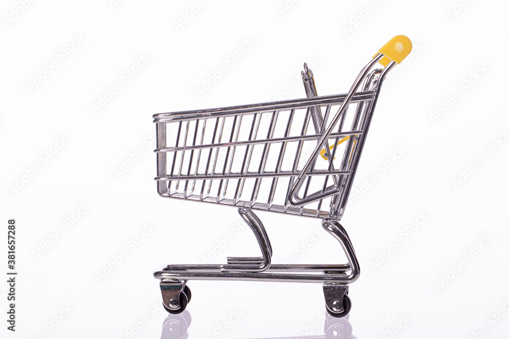 Small empty shopping cart trolley isolated on white background. Department store, supermarket, e-commerce, online shopping, marketing deal poster, black friday sale concept. Copy space, side view Small empty shopping cart trolley isolated on white background. Department store, supermarket, e-commerce, online shopping, marketing deal poster, black friday sale concept. Copy space, side view