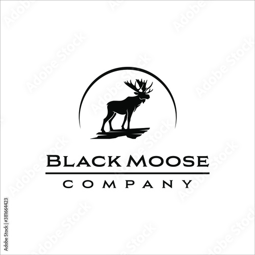 Moose that stands on the edge of a rock cliff with a classic design