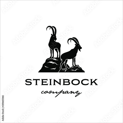 Two steinbock standing on a rock cliff with a classic design