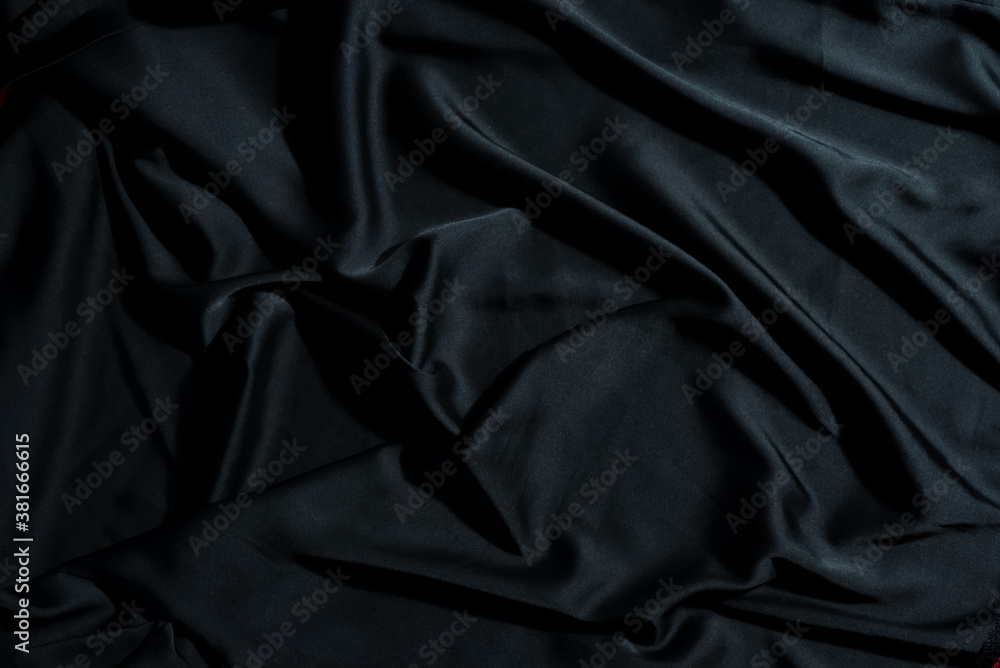 Crumpled textile fabric background of black color. Crumpled textile fabric background of black color.