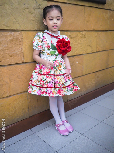 beautiful girl wearing a floral dress in retro style.