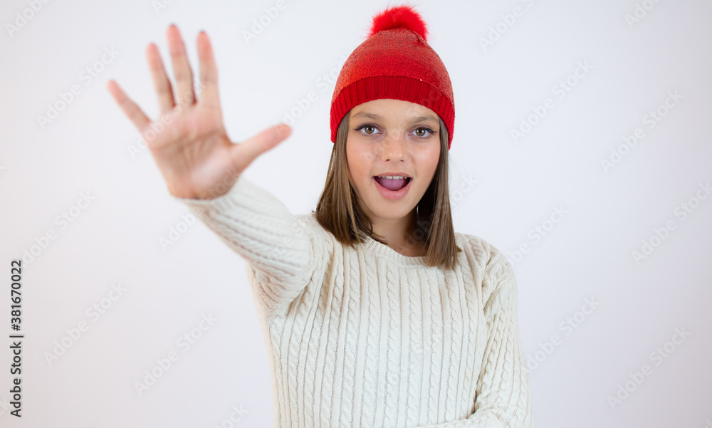 Close up portrait of a girl showing stop gesture with her palm isolated over white background Close up portrait of a girl showing stop gesture with her palm isolated over white background