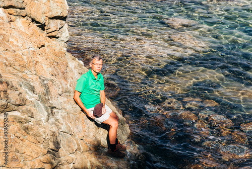Mature man on cliffs of Mediterranean Sea © amelie