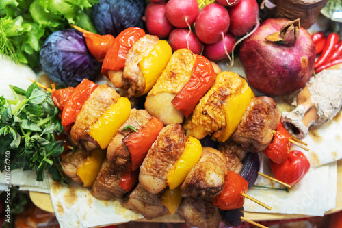Chicken skewers with vegetables and herbs. Cooking poultry meat on skewers.