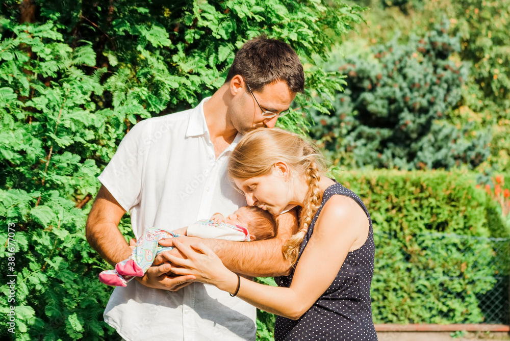 Happy parents with newborn baby outdoors Happy parents with newborn baby outdoors