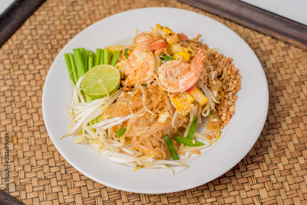 Thai traditional food  Pad Thai Noodles with shrimp in dish on wooden table