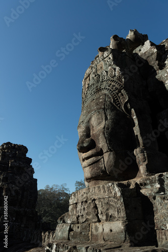 The Bayon is a richly decorated Khmer temple with the multitude of serene and smiling stone face stands at the center of Angkor Thom, Siem Reap, Cambodia. © ULTRAPOK