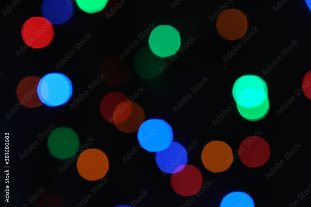 Colorful defocused bokeh lights on black background.Abstract multicolored holiday lights