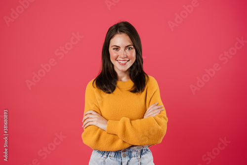 Image of happy beautiful girl posing with arms crossed