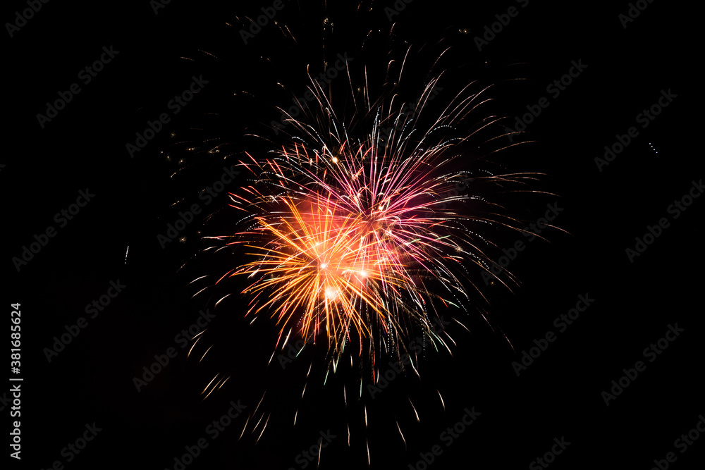 Red orange and yellow fireworks in the night sky