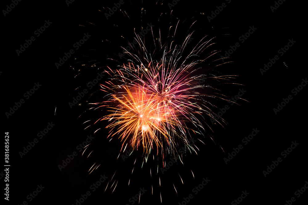 Red orange and yellow fireworks in the night sky Red orange and yellow fireworks in the night sky