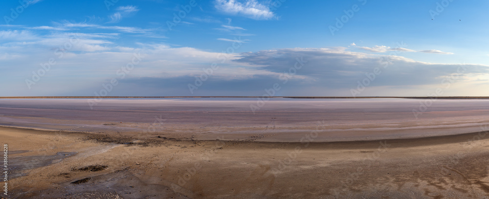 Fototapeta premium Sunset on the Genichesk pink extremely salty lake (colored by microalgae with crystalline salt depositions), Ukraine.