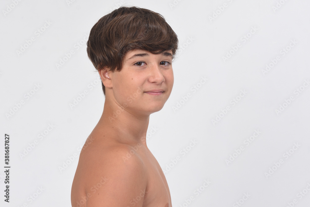 portrait of a shirtless teen boy on white background, looking at camera portrait of a shirtless teen boy on white background, looking at camera