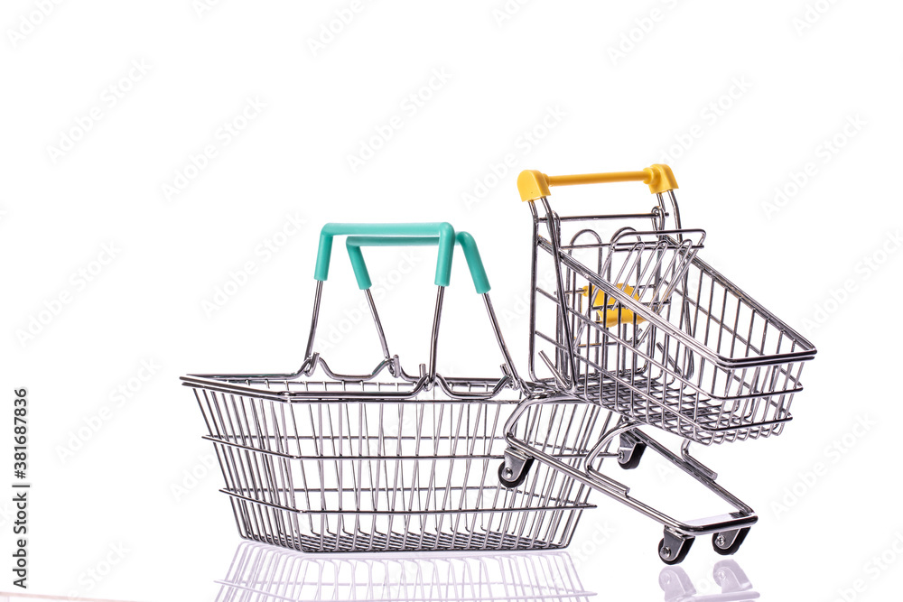 Small empty shopping cart and metal shopping basket isolated on white background. Store, supermarket, e-commerce, online shopping, special offer, poster, black friday sale concept. Copy text space Small empty shopping cart and metal shopping basket isolated on white background. Store, supermarket, e-commerce, online shopping, special offer, poster, black friday sale concept. Copy text space