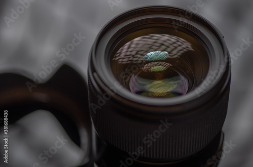 Photo lens photographed in the studio close-up on a dark background.