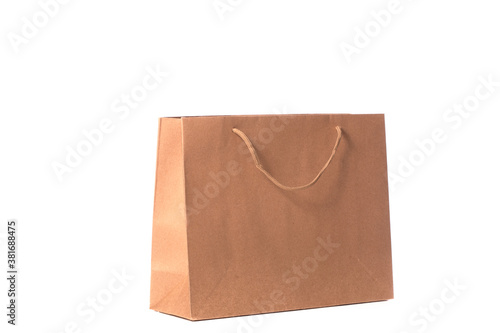 Craft reusable paper bag isolated on white background. Eco-friendly shopping bag, brown carrier bag with handles, recycled paper package, delivery service, environmental protection concept. Copy space