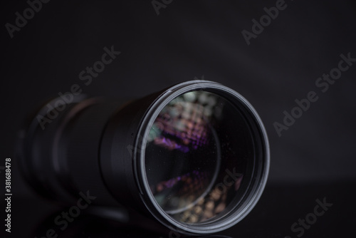 Photo lens photographed in the studio close-up on a dark background.