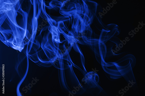 Blue flowing smoke on black background