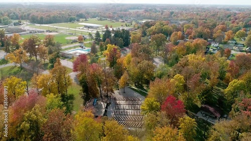 a drone shot flying over the treetops in fall photo