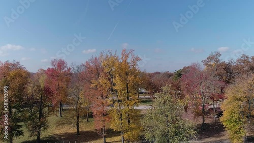 Flying over a local small town park in mid fall photo